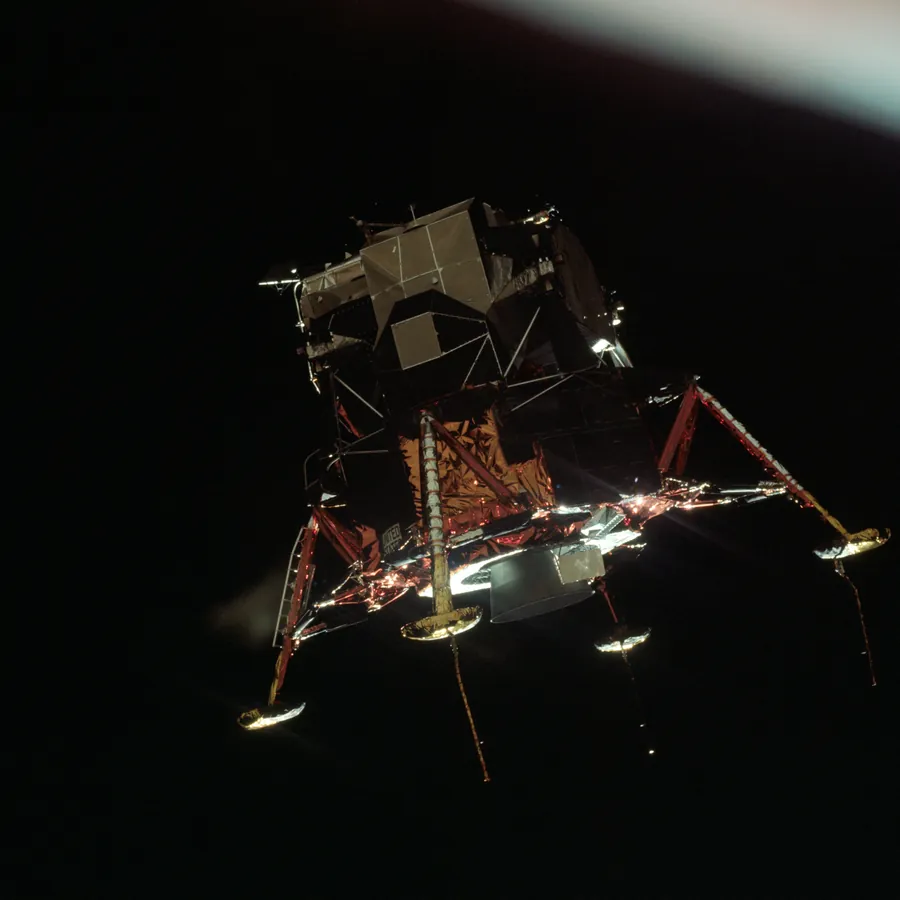 The lunar module Eagle, legs extended, alone against the black of lunar orbit.