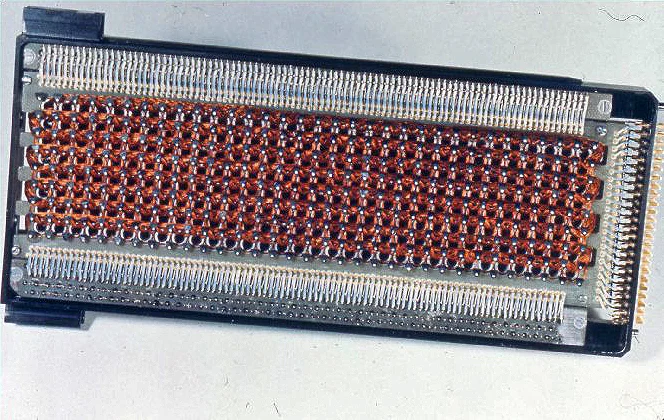 A core rope memory module: a long frame packed with rows of tiny ferrite cores and woven copper wire.